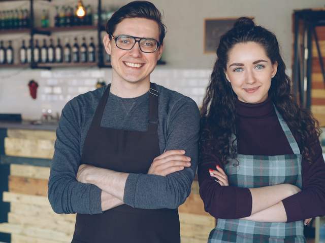 Cass with a café owner going through her financials